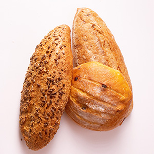 three types of baked bread in a white background